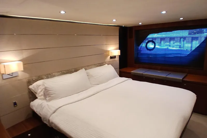  Yacht Photos Pics Luxurious bedroom interior of 2015 Princess V62-S yacht with modern lighting and large window.