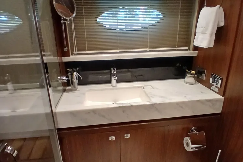  Yacht Photos Pics Luxurious bathroom in 2015 Princess V62-S yacht with marble countertop and modern fixtures.