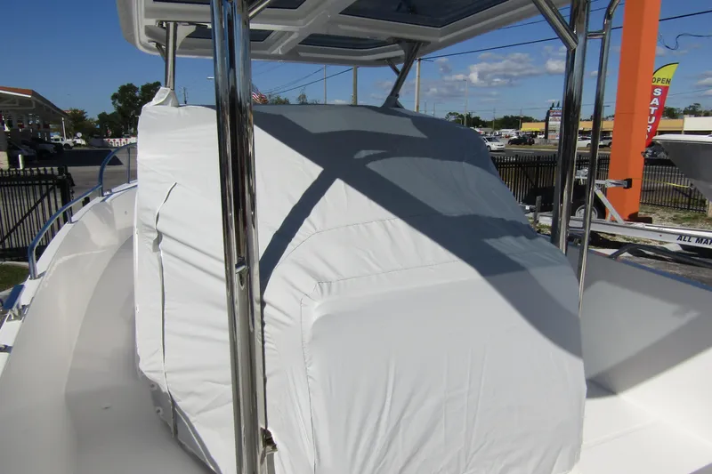 Yacht Photos Pics 2025 Nimbus Tender 9 boat with covered console, parked outdoors under clear sky.
