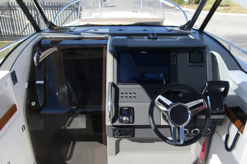  Yacht Photos Pics 2025 Nimbus Tender 9 boat dashboard with steering wheel and navigation controls.