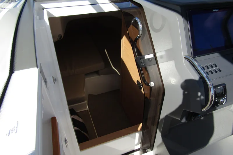  Yacht Photos Pics Interior cabin view of 2025 Nimbus Tender 9 boat, featuring modern design and controls.