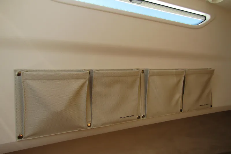  Yacht Photos Pics Interior storage pockets on Nimbus Tender 9, 2025 model, with natural light from window.