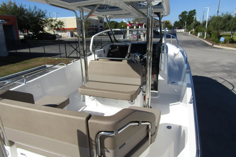  Yacht Photos Pics 2025 Nimbus Tender 9 boat with beige seating and sleek design in a parking area.
