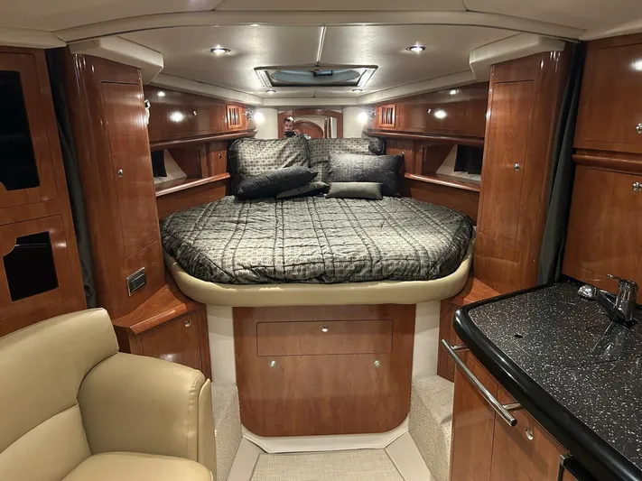  Yacht Photos Pics Luxurious 2008 Four Winns V358 cabin interior with elegant wood finish and cozy bedding.