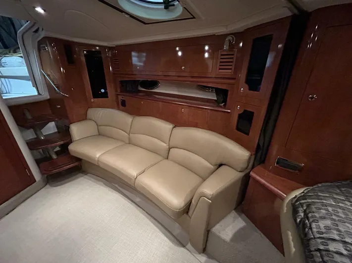  Yacht Photos Pics Luxurious interior of 2008 Four Winns V358 yacht with beige leather seating and wooden cabinetry.