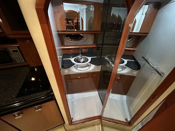  Yacht Photos Pics 2008 Four Winns V358 yacht interior with modern kitchenette and mirrored cabinetry.