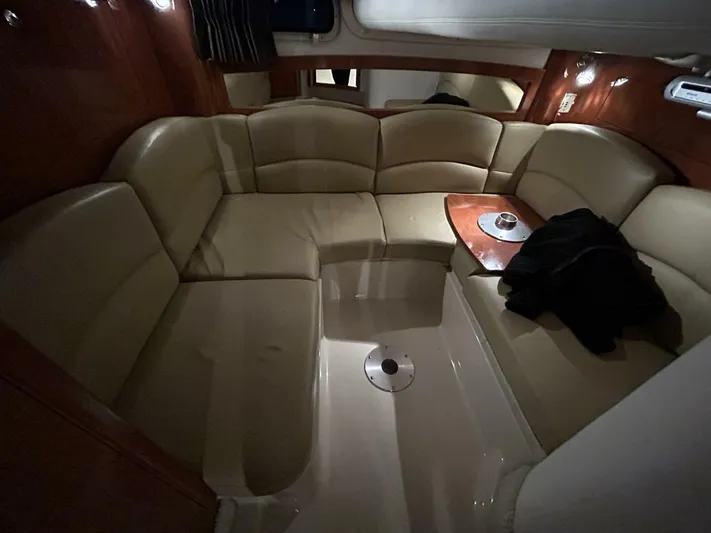  Yacht Photos Pics 2008 Four Winns V358 yacht interior with beige leather seating and wooden table.