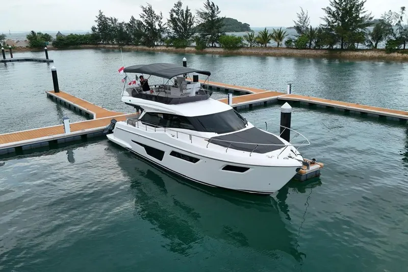 Yacht Photos Pics 2022 Ferretti Yachts 500 docked in a serene marina setting.