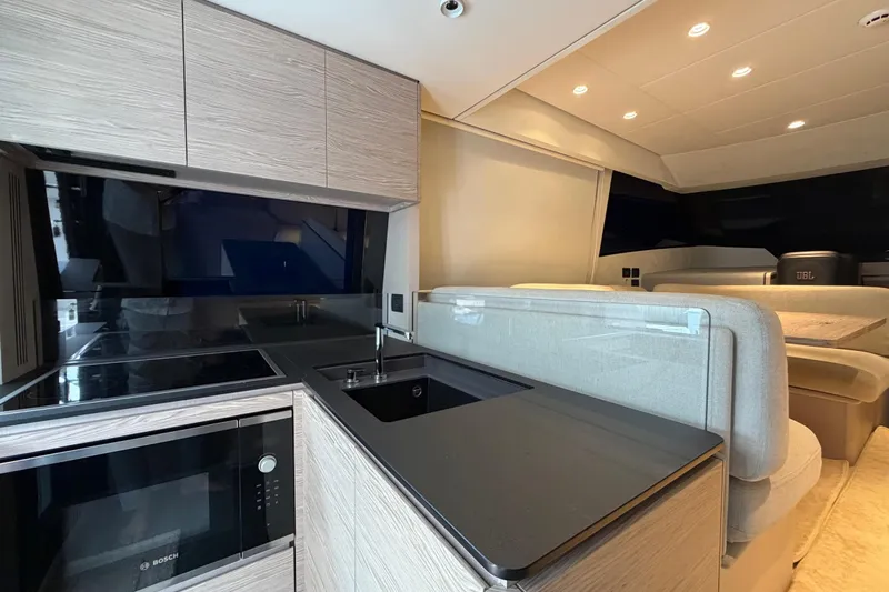  Yacht Photos Pics Modern kitchen and seating area in 2023 Ferretti Yachts 500, featuring sleek design and appliances.