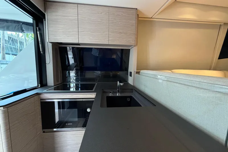  Yacht Photos Pics Modern kitchen interior of 2023 Ferretti Yachts 500, featuring sleek cabinetry and appliances.