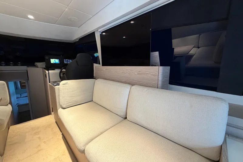  Yacht Photos Pics Luxurious interior of 2023 Ferretti Yachts 500 with plush seating and modern helm.