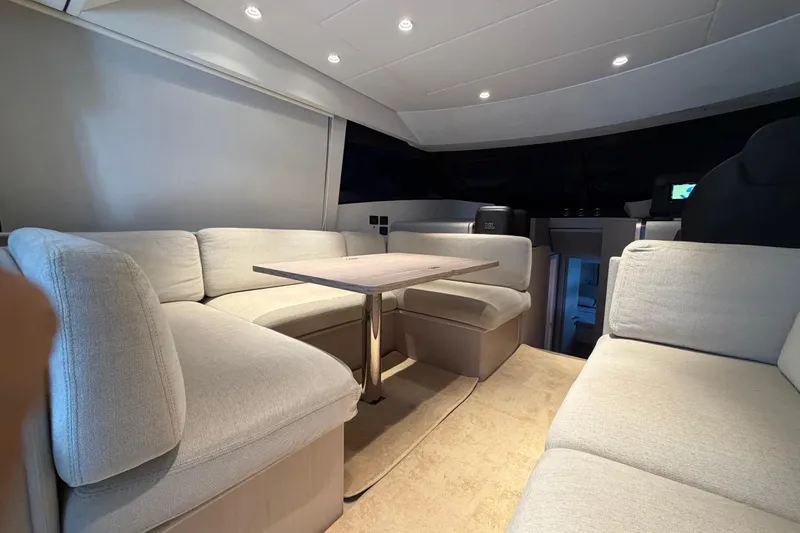  Yacht Photos Pics Luxurious interior of 2023 Ferretti Yachts 500 with plush seating and elegant table.