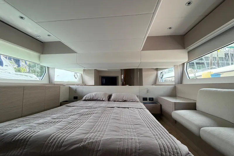  Yacht Photos Pics Luxurious bedroom interior of 2023 Ferretti Yachts 500, featuring modern design and large windows.