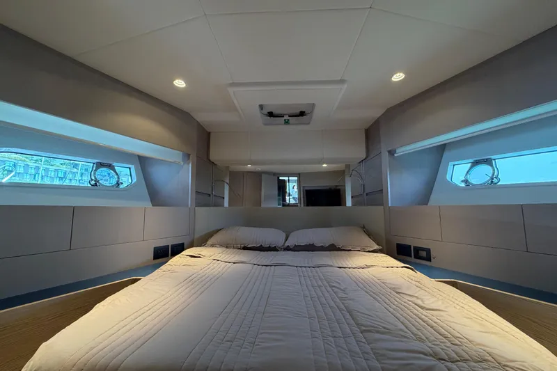  Yacht Photos Pics Luxurious bedroom interior of 2023 Ferretti Yachts 500 with modern design and ambient lighting.