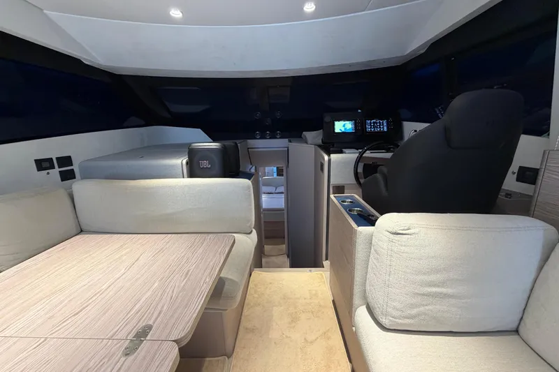 Yacht Photos Pics Luxurious interior of 2023 Ferretti Yachts 500, featuring modern seating and navigation equipment.