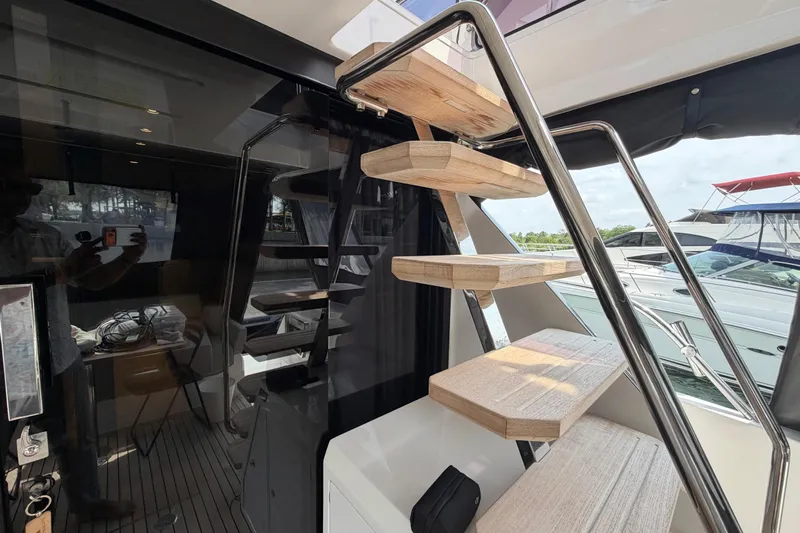  Yacht Photos Pics Modern staircase on 2023 Ferretti Yachts 500, featuring sleek design and wooden steps.