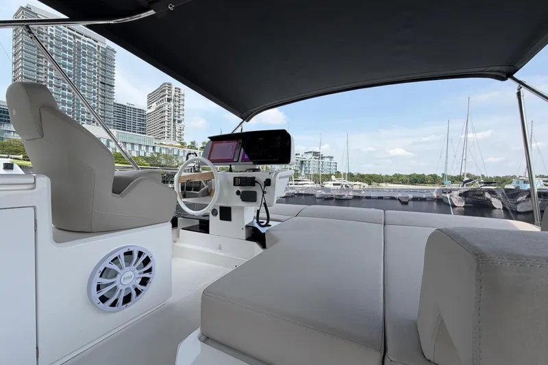  Yacht Photos Pics Luxurious 2023 Ferretti Yachts 500 interior with marina view, featuring modern helm and seating.