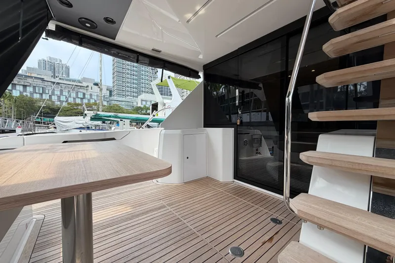 Yacht Photos Pics 2023 Ferretti Yachts 500 deck with wooden flooring and modern design elements.