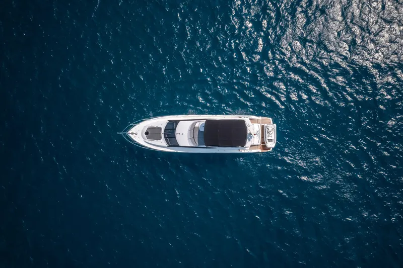 M/y Corazon De Leon Yacht Photos Pics Aerial view of 2016 Sunseeker Manhattan 65 yacht on deep blue ocean.