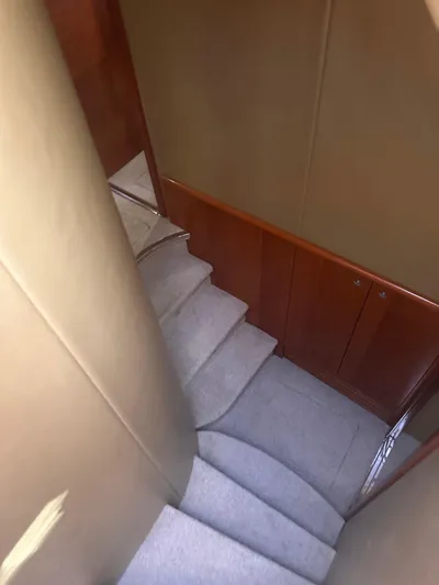  Yacht Photos Pics Staircase inside 2007 Azimut 55E yacht with carpeted steps and wooden paneling.