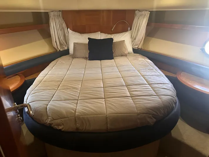  Yacht Photos Pics Luxurious bedroom in 2007 Azimut 55E yacht with cozy bedding and elegant decor.