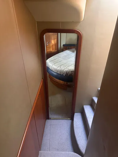  Yacht Photos Pics Interior view of 2007 Azimut 55E yacht, featuring a cozy bedroom and staircase.