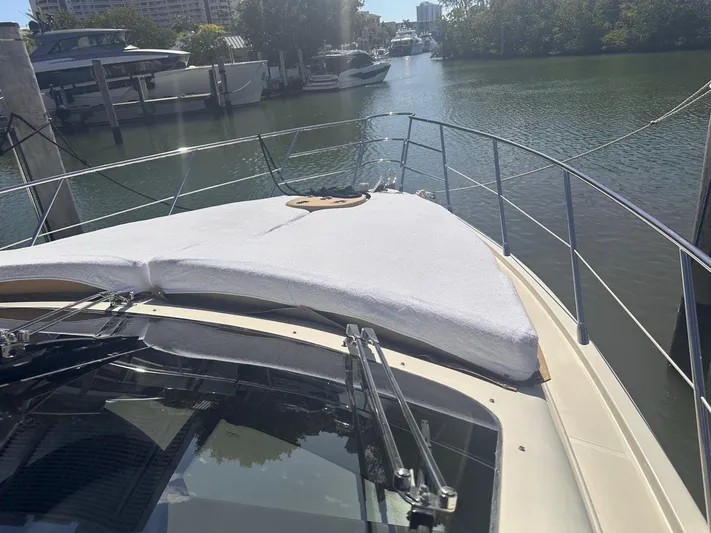  Yacht Photos Pics 2007 Azimut 55E yacht bow view, docked in a serene marina setting.