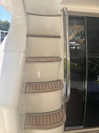  Yacht Photos Pics Staircase on 2007 Azimut 55E yacht with wooden steps and metal railing.