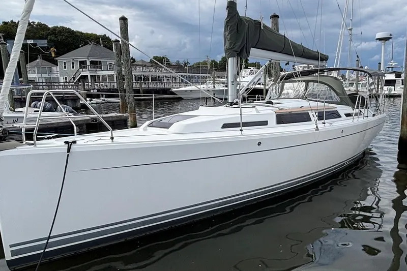 Respite Yacht Photos Pics 2014 Hanse 345 sailboat docked at a marina under cloudy skies.