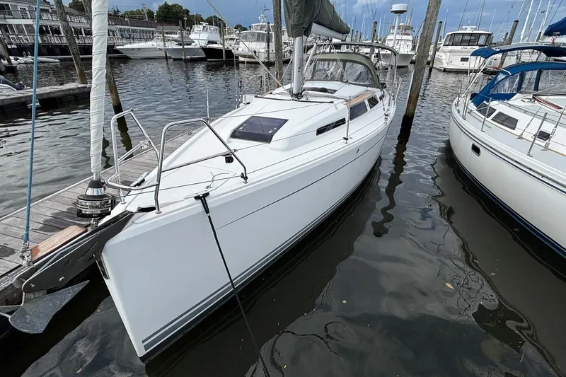 Respite Yacht Photos Pics 2014 Hanse 345 sailboat docked in a marina, surrounded by other boats.