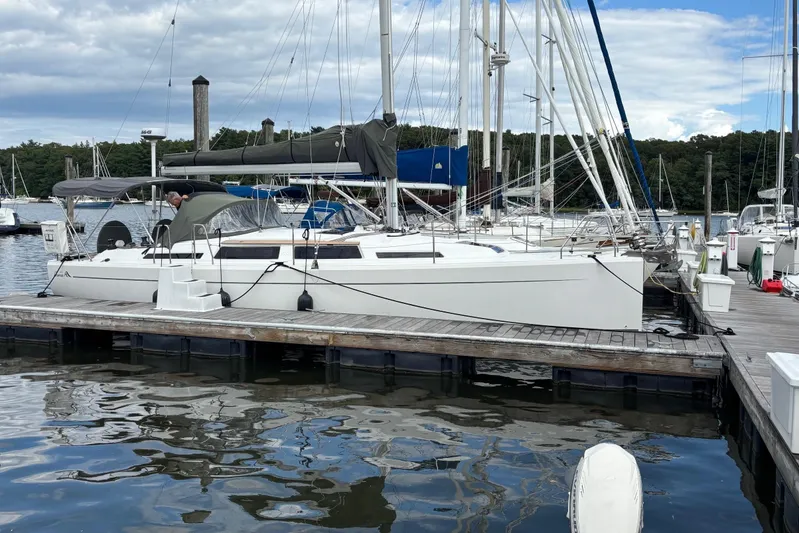 Respite Yacht Photos Pics 2014 Hanse 345 sailboat docked at a marina, surrounded by calm water and other boats.