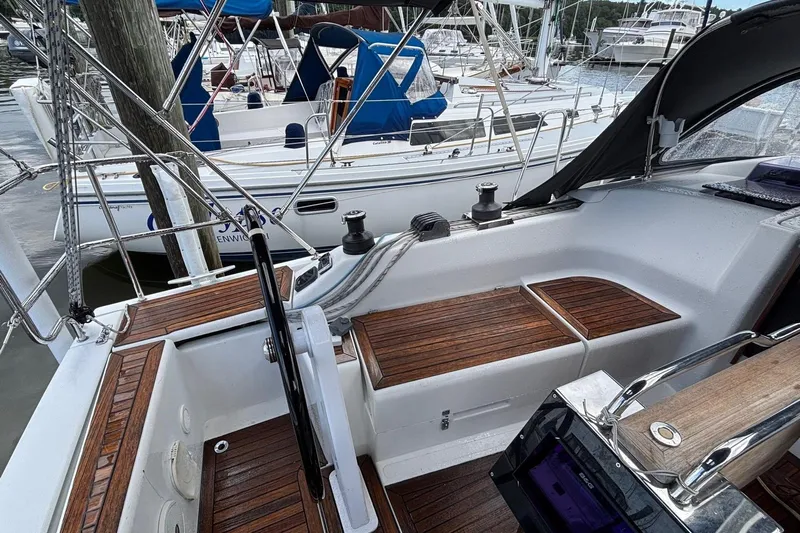 Respite Yacht Photos Pics Sailboat cockpit with wooden seating, Hanse 345, 2014 model, docked at marina.