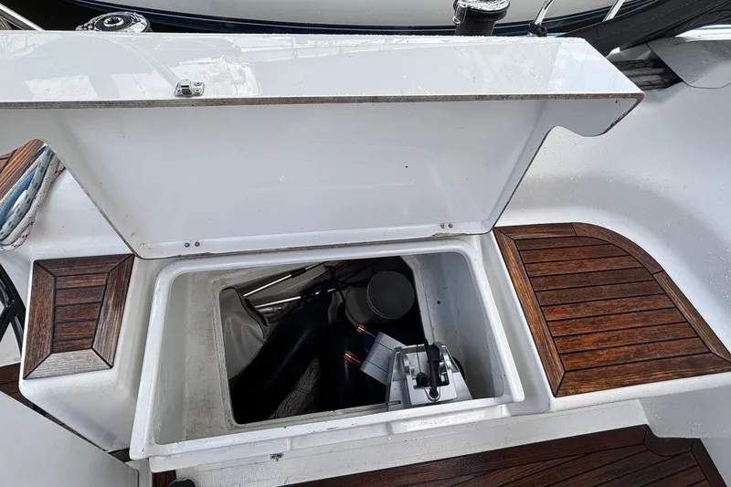 Respite Yacht Photos Pics Open storage compartment on 2014 Hanse 345 yacht with wooden deck accents.