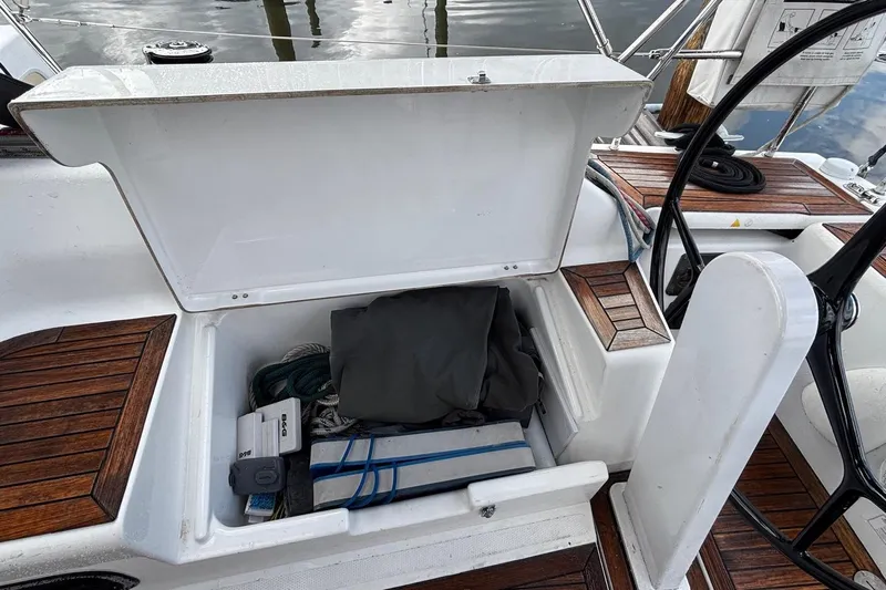 Respite Yacht Photos Pics Open storage compartment on 2014 Hanse 345 sailboat, showing ropes and equipment.