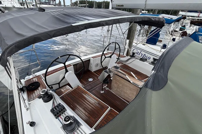 Respite Yacht Photos Pics 2014 Hanse 345 sailboat cockpit with dual steering wheels and wooden deck.