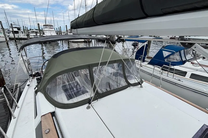 Respite Yacht Photos Pics 2014 Hanse 345 sailboat docked at marina, featuring green canopy and clear windows.