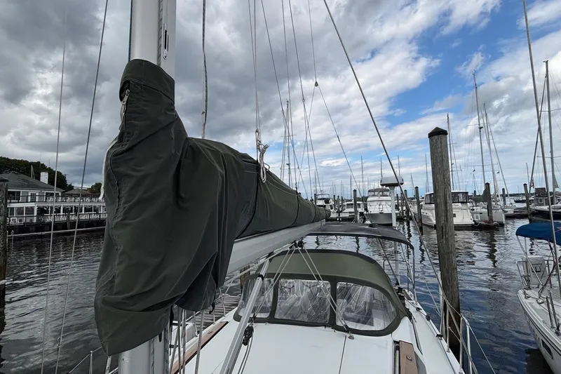 Respite Yacht Photos Pics 2014 Hanse 345 sailboat docked at marina under cloudy sky.