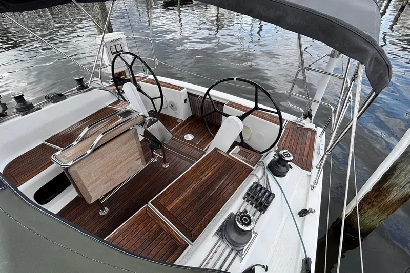 Respite Yacht Photos Pics Cockpit of 2014 Hanse 345 sailboat with dual steering wheels and wooden deck.