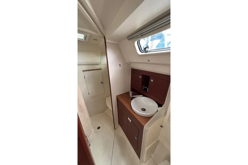 Respite Yacht Photos Pics 2014 Hanse 345 yacht bathroom with sink, wooden cabinetry, and window.