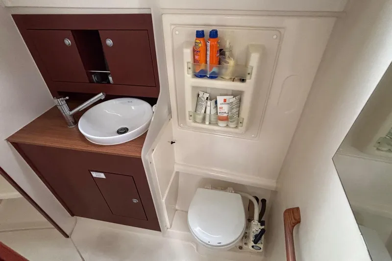 Respite Yacht Photos Pics Compact bathroom in 2014 Hanse 345 yacht with sink, toilet, and toiletries storage.