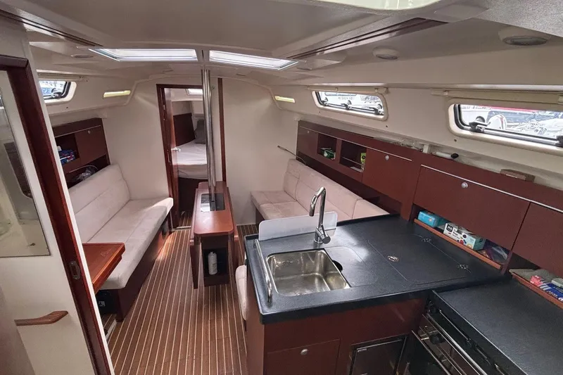 Respite Yacht Photos Pics Interior of 2014 Hanse 345 yacht with modern kitchen and cozy seating area.