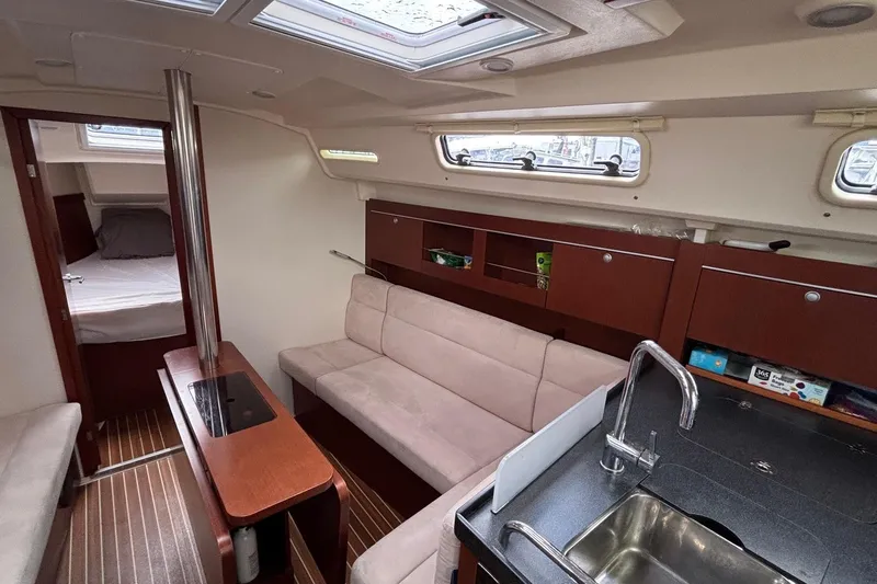 Respite Yacht Photos Pics Interior of 2014 Hanse 345 yacht with modern kitchen and cozy seating area.