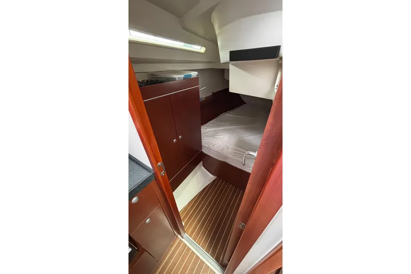 Respite Yacht Photos Pics 2014 Hanse 345 yacht interior cabin with wooden flooring and cozy bed.