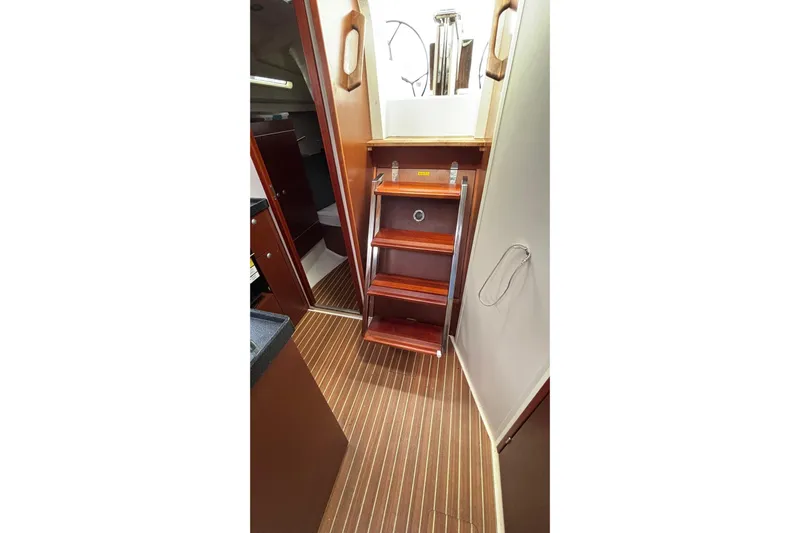 Respite Yacht Photos Pics Interior of 2014 Hanse 345 yacht with wooden steps and striped flooring.