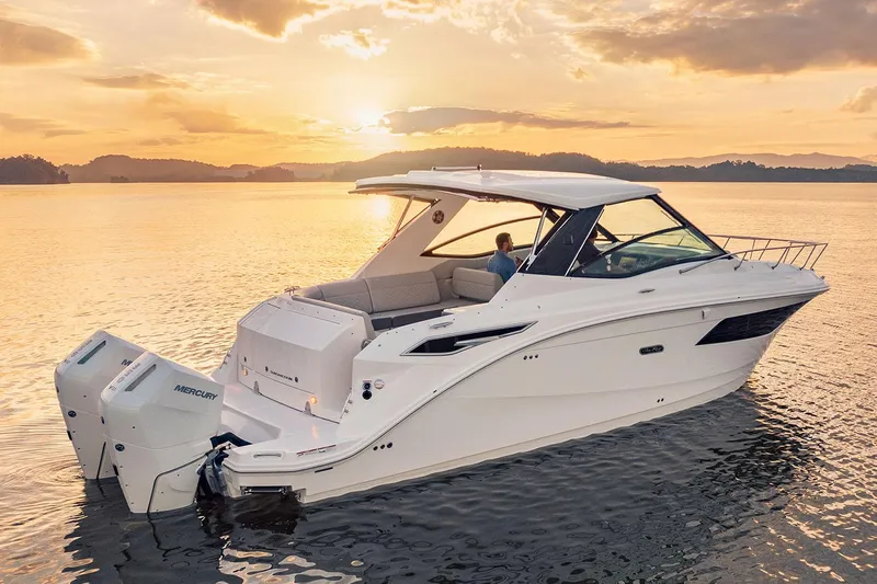  Yacht Photos Pics Manufacturer Provided Image: 2025 Sea Ray Sundancer 320 Outboard cruising at sunset on calm waters.