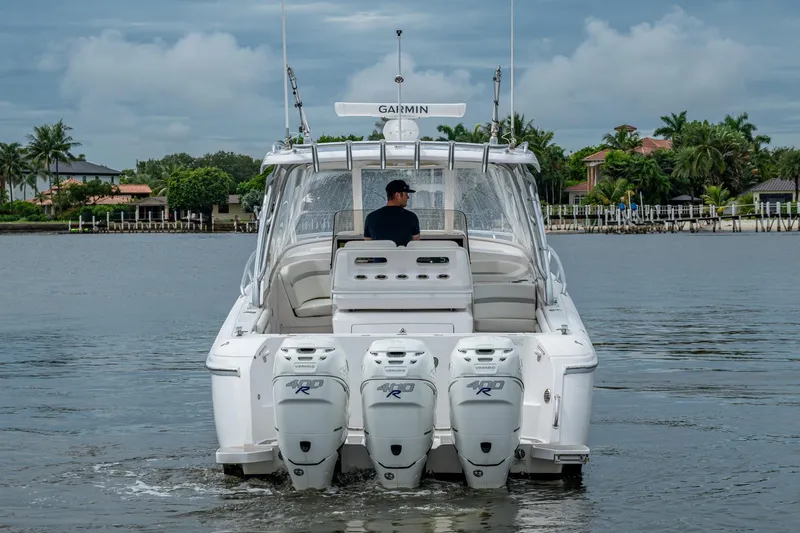  Yacht Photos Pics 2019 Intrepid 407 Cuddy boat with triple outboard engines on a calm waterway.