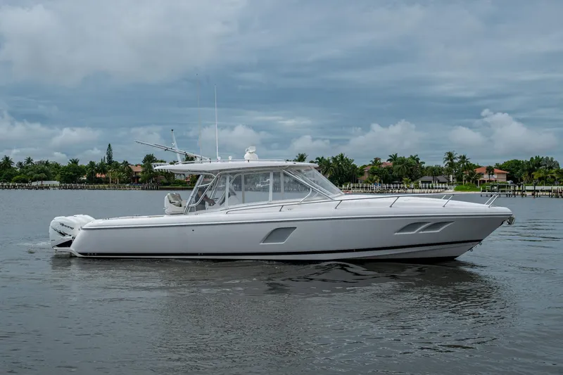  Yacht Photos Pics 2019 Intrepid 407 Cuddy boat on calm water under cloudy sky.