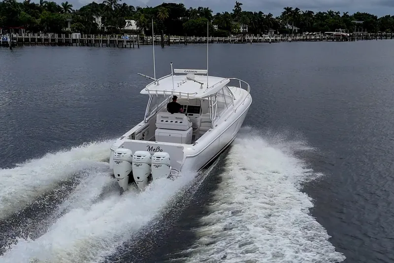  Yacht Photos Pics 2019 Intrepid 407 Cuddy cruising on a calm waterway, showcasing powerful engines.