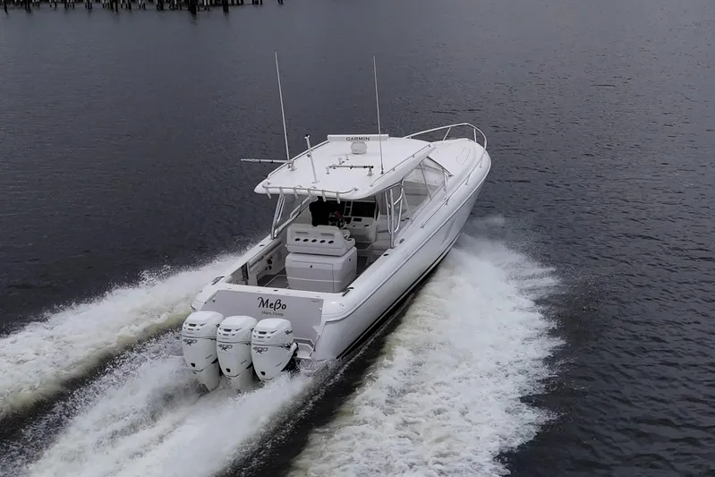  Yacht Photos Pics 2019 Intrepid 407 Cuddy boat cruising on water with triple outboard engines.
