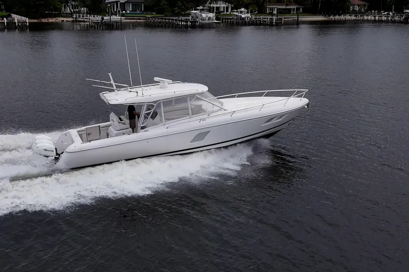  Yacht Photos Pics 2019 Intrepid 407 Cuddy cruising on calm waters, side view.